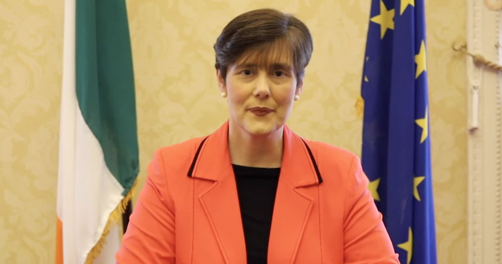 Minister Norma Foley at a press conference in front of the Irish and EU flags. This story details the public demand for sex education reform in Ireland.