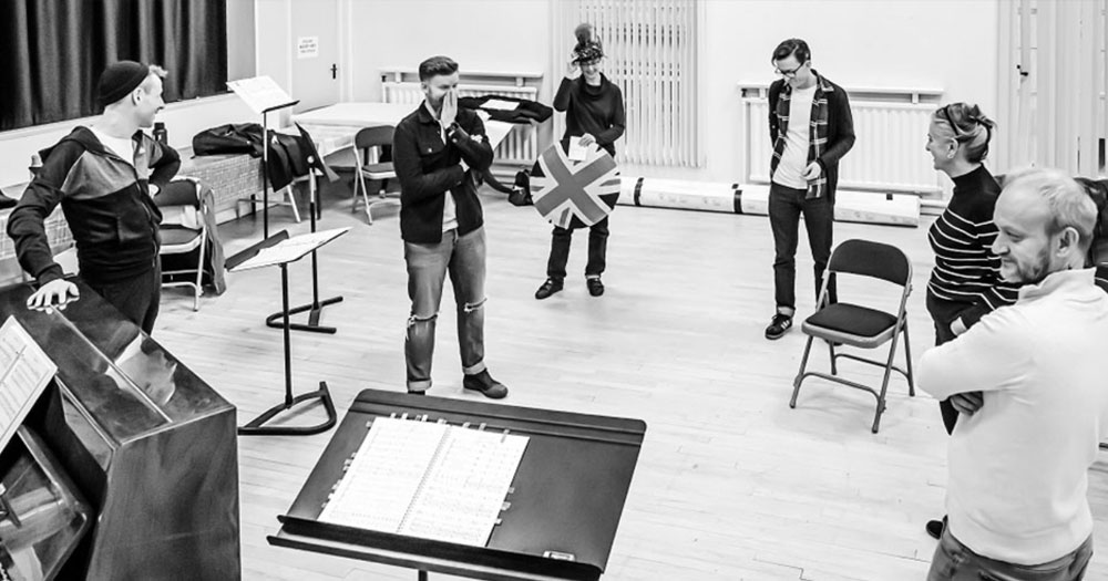 Black and white photograph of the cast rehearsing for Abomination: a DUP Opera ahead of the Abbey show.