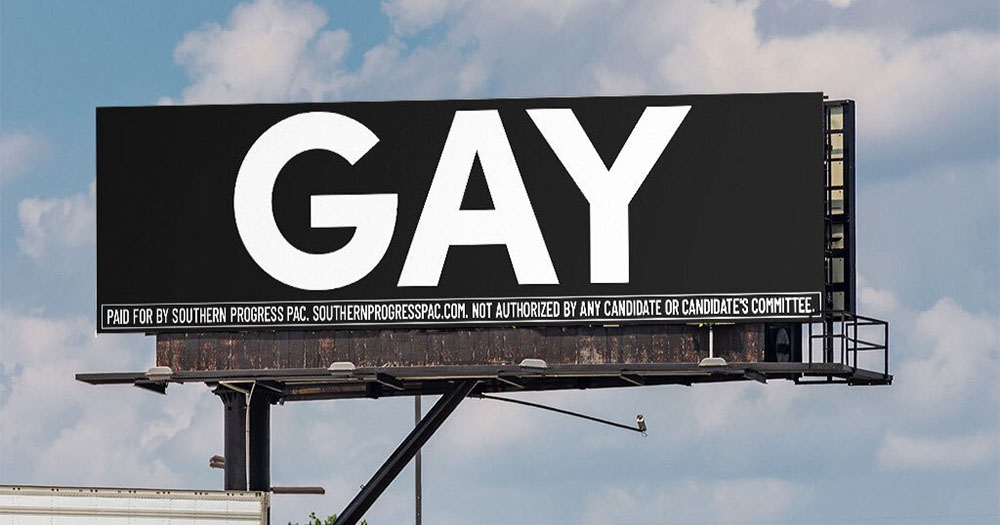 A billboard with large white text saying GAY on it in a direct protest against the Don't Say Gay Bill in Florida