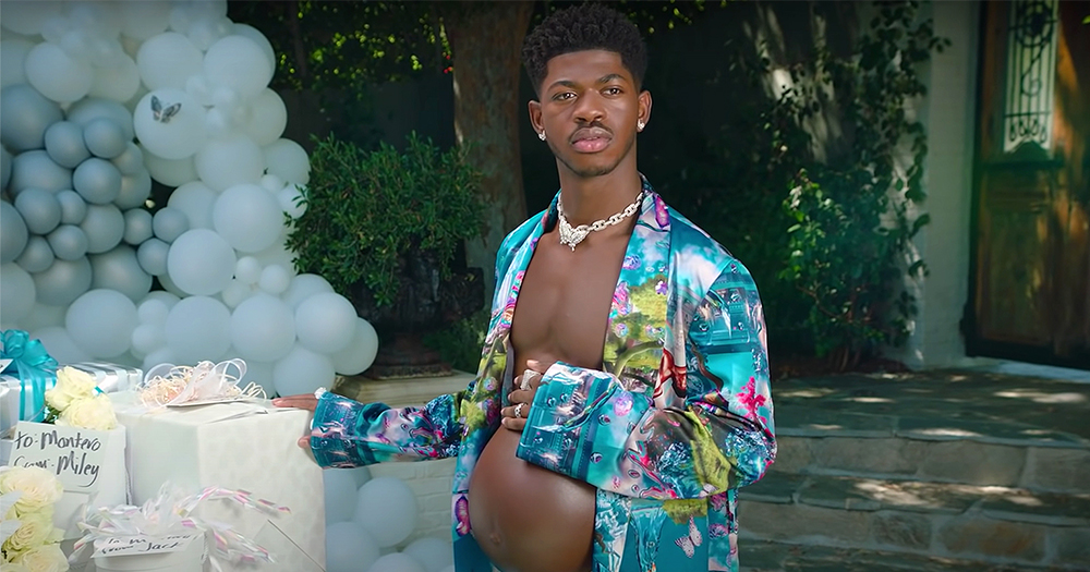 Lil Nas X stands with a prosthetic belly for his fake pregnancy photoshoot as part of Montero's promotion