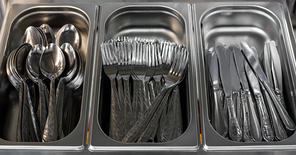 Silver trays of cutlery as Aramark is awarded the catering contract for Ukrainian refugee centres.