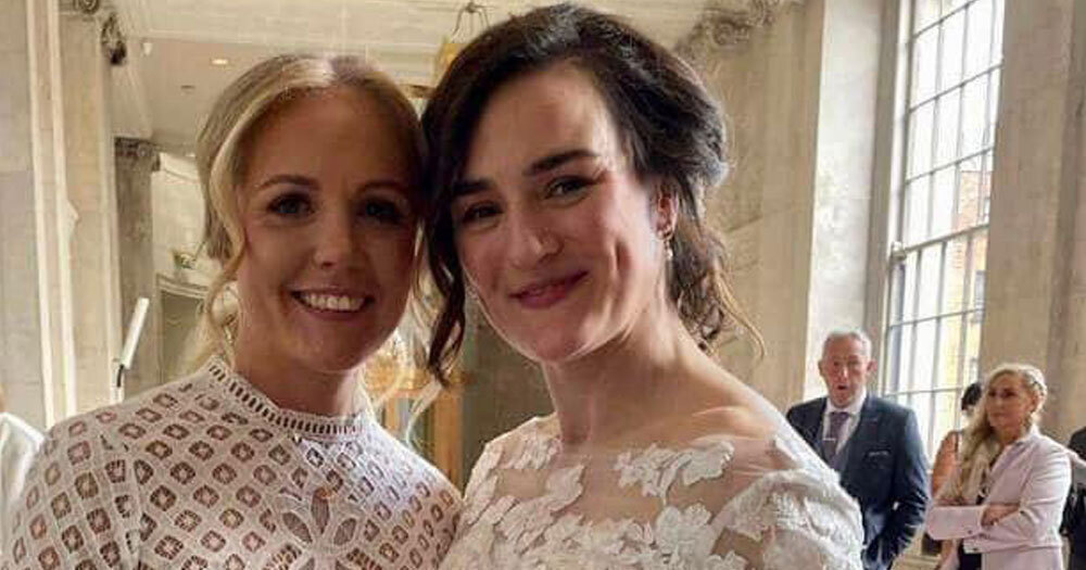 Kellie Harrington and Mandy Loughlin smiling at the camera in their wedding dresses.