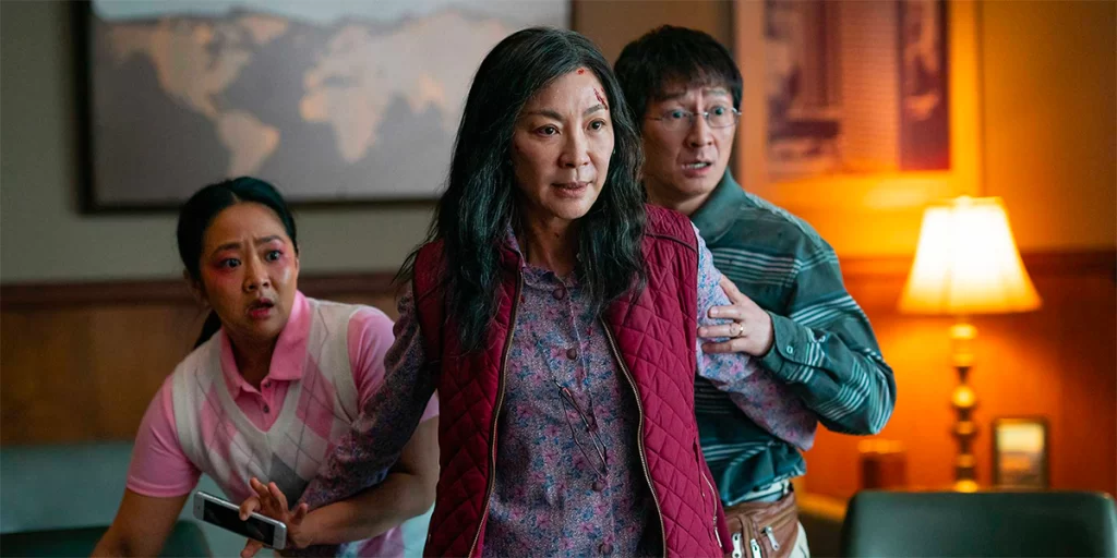 Image from Everything Everywhere All At Once Film with Evelyn protecting her daughter and husband.