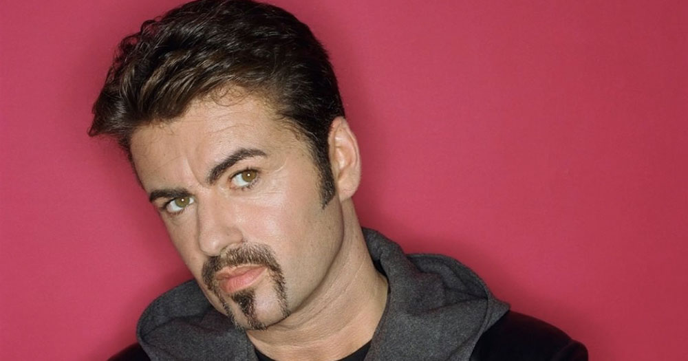 Close up image of George Michael against a red backdrop