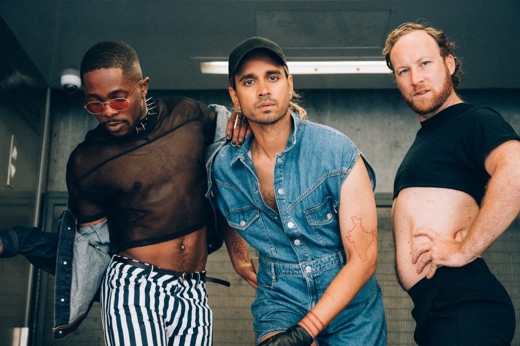 an image of three people posing together.