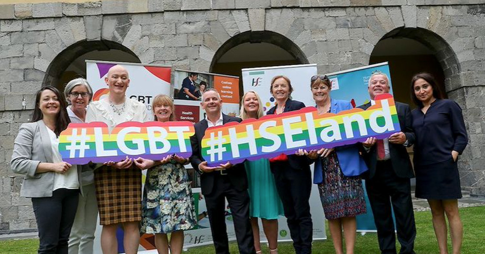 an image of LGBT Ireland and HSE representatives. They are each holding signs saying #LGBT and #HSEland.