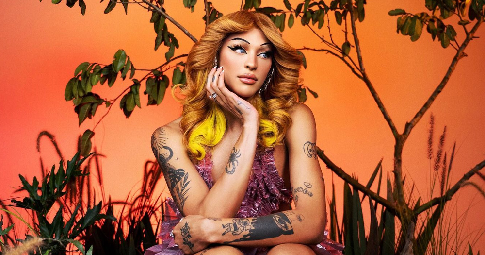 Brazilian drag queen Pablo Vittar, who is performing a Mother gig in Dublin tomorrow, posing in front of an orange background with trees.
