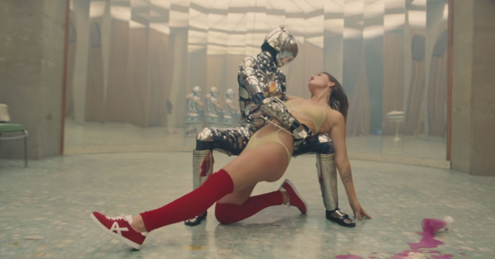 Still from the new Tove Lo single, showing Tove in the arms of a robot in a dance studio