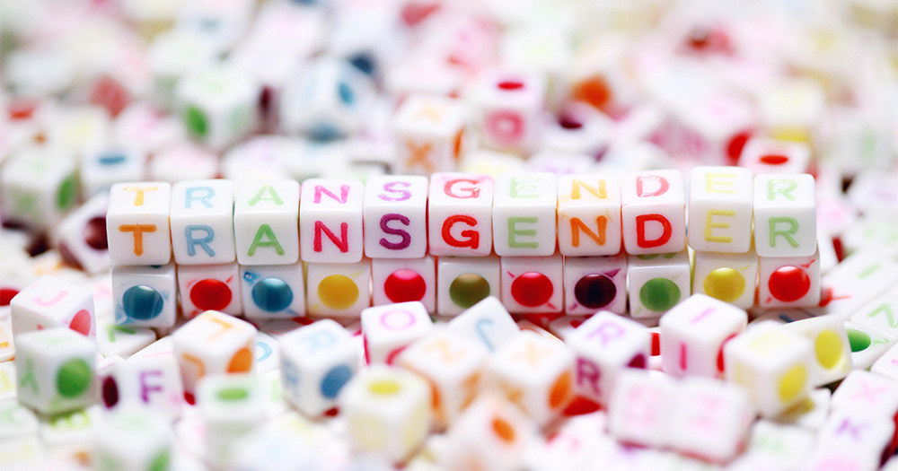 Colourful beads spelling out the word 'Transgender'. This story details the blocking of the Alabama law to bank gender-affirming care for Trans youth.