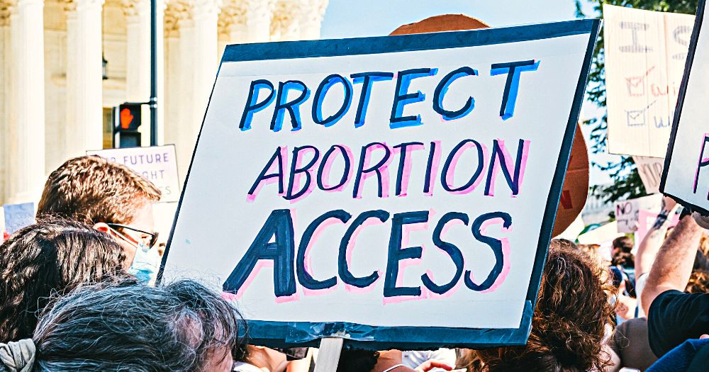 "Protect abortion access" sign on a protest against the abortion rights ban which also affects the LGBTQ+ community in the US