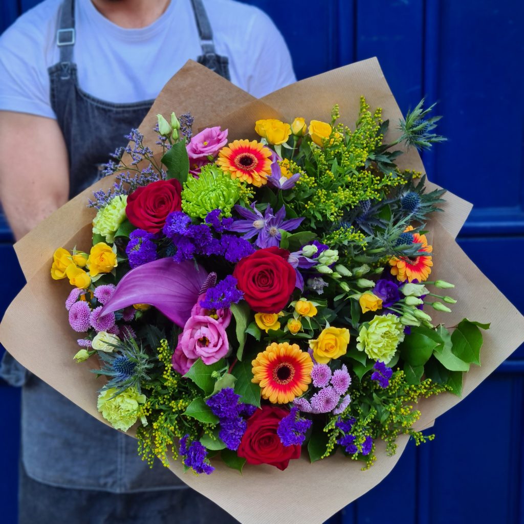 This article is about taking care of your mental health in winter. The image shows a bouquet of flowers from a Pride collection that will donate proceeds to BeLonG To.
