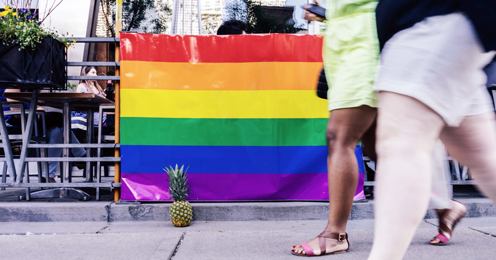 A Pride flag in the street. In this article, the best Pride destination for your travel.