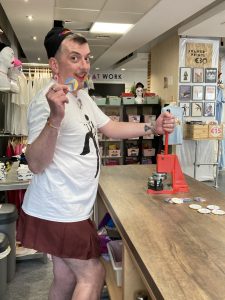 Colm Molloy posing with their badges of the Ukranian solidarity Pride flag design.