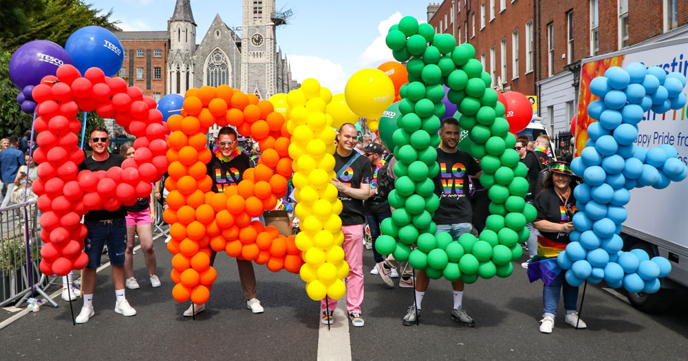 Balloons spelling out the word 'PRIDE' in rainbow colours carried by people in the Dublin Pride parade 2022