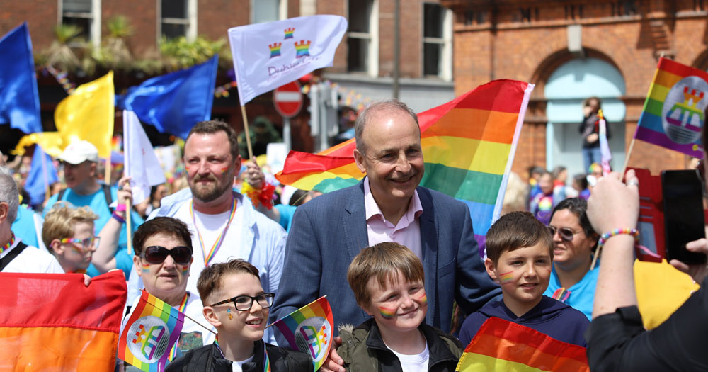 An Taoiseach Michael Martin surrounded by children waving Pride flags before speaking at the Dublin Pride about Conversion Therapy.