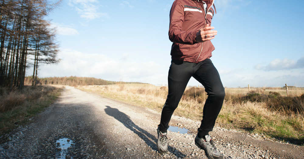 Photo of a jogger on a road.