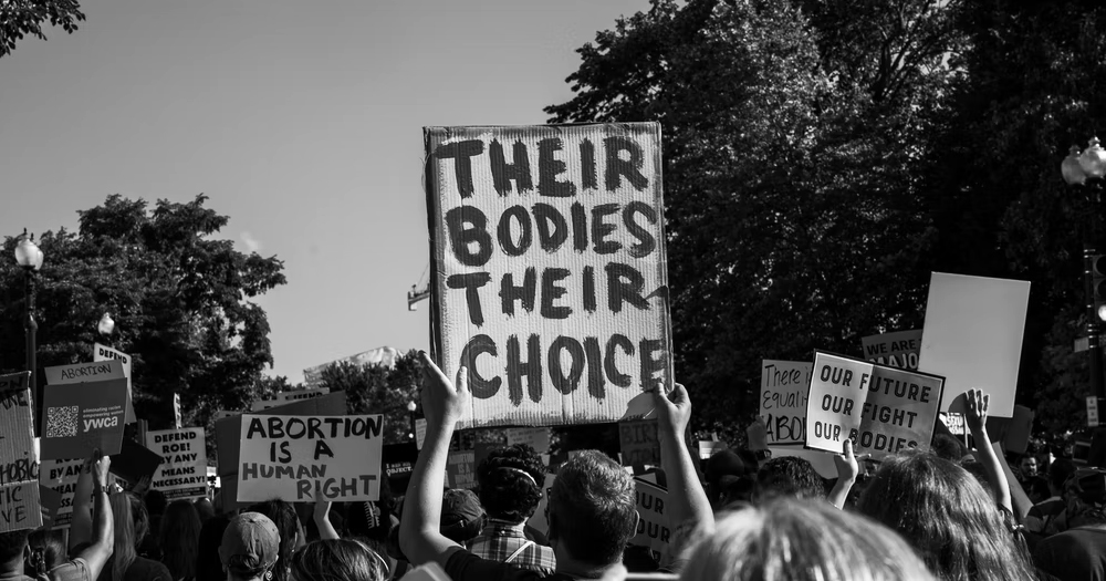 This article is about abortion rights in Ireland. In the picture, people marching in a protest for abortion rights, carrying signs with supportive messages.