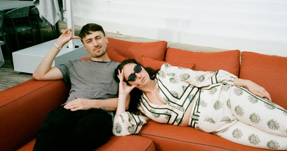 photo of cat and pat, hosts of seek treatment which will go live in Dublin for the first time, lying on an orange sofa
