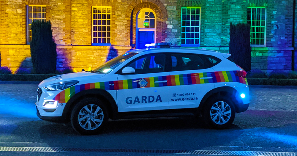 Rainbow garda car in front of rainbow lights in advance of tonights emergency motion.