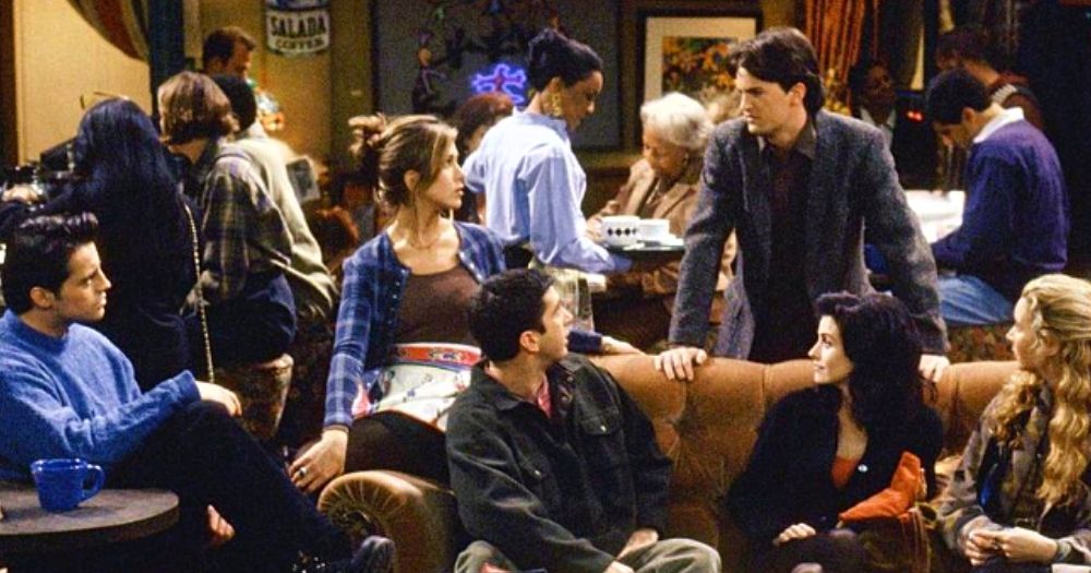 the cast of Friends sitting around a table in a coffee shop to illustrate the mistake Marta Kauffman made when misgendering a Trans character