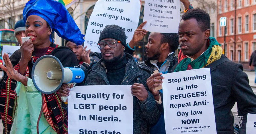 The photograph shows a protest over the sentencing of 3 gay Nigerian men to be stoned to death. In the photograph the demonstrators are holding homemade placards calling for changes in Nigerian law.