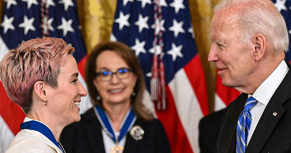 ​​Megan Rapinoe receiving the Medal of Freedom from President Biden, at a ceremony where she honoured Brittney Griner.