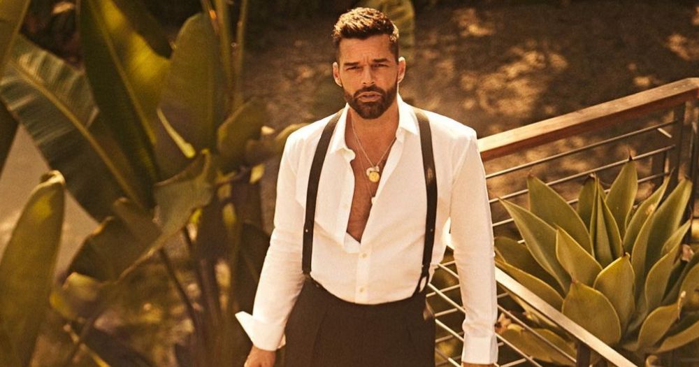 Photo of Ricky Martin, who denies allegations made by his nephew, on a balcony wearing a white shirt