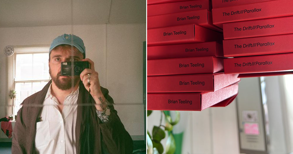 The photograph shows a split screen with two images. On the left is a self-portrait of artist Brian Teeling taken with an instant colour film camera into a mirror. He is wearing a blue baseball cap. The image on the right shows the spines of a stack of red books which read Brian Teeling - The Drift///Parallax.