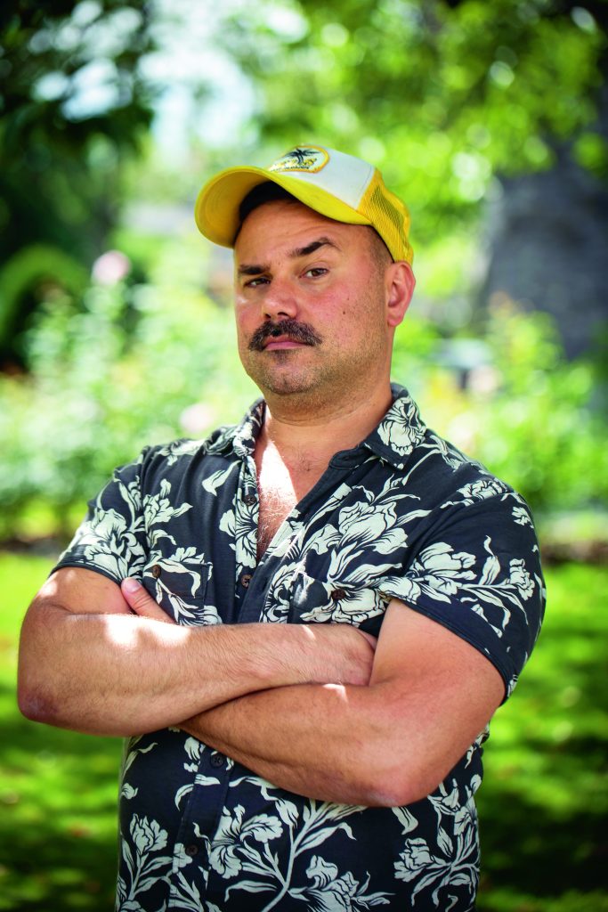 Author Conner Habib posing for a photo outdoors with folded arms