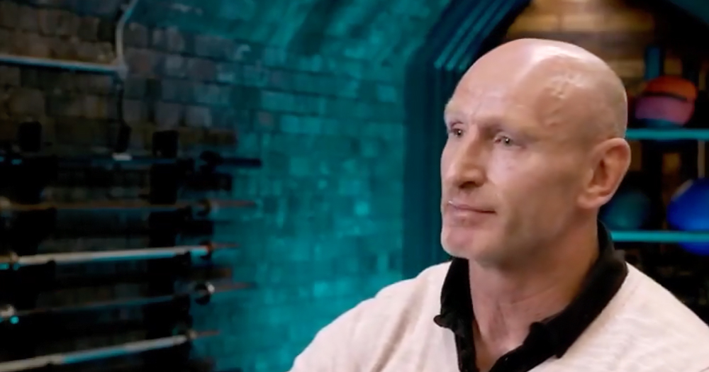 The image is a still from a documentary featuring the HIV positive former rugby star Gareth Thomas. The head and shoulders profile shows Thomas to the right of the screen in front of a brick wall.