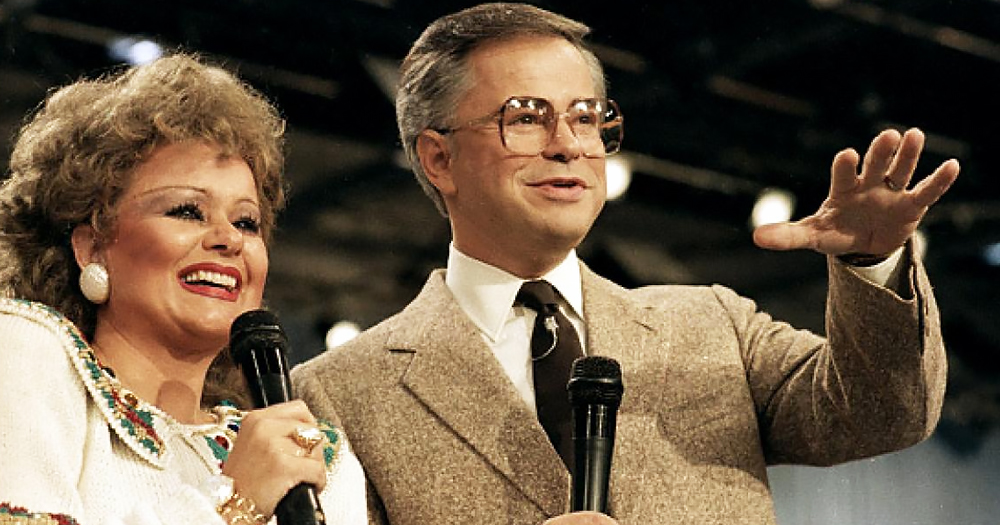 Photo of gay icon Tammy Faye, protagonist of a new upcoming movie, and Jim Bakker speaking on microphones.