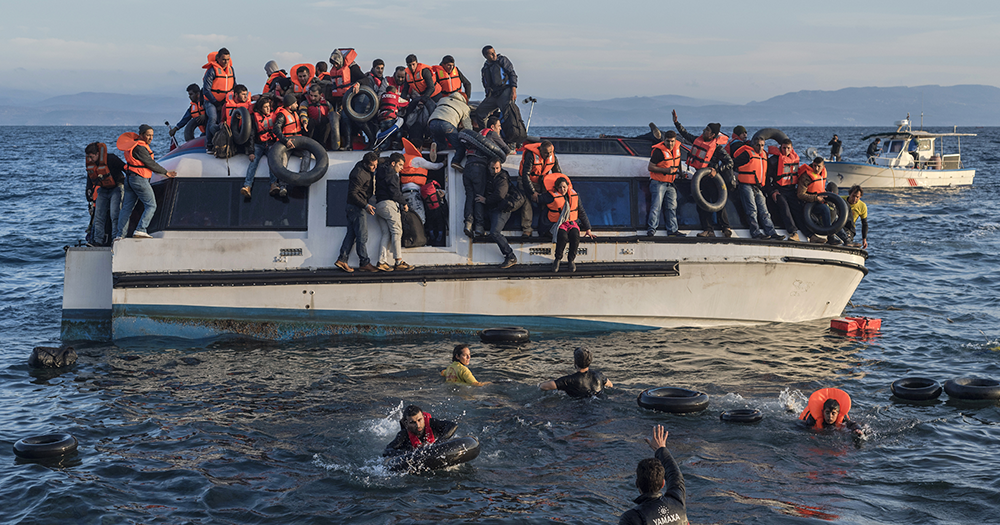 Asylum seekers arriving to the coast on a boat.