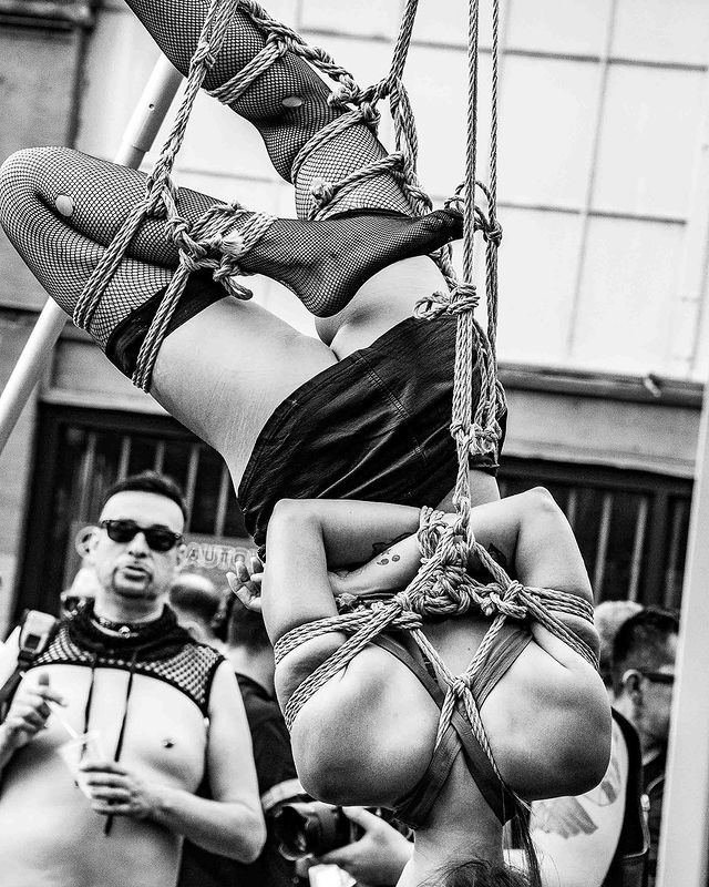A person hanging in bondage gear at Folsom.