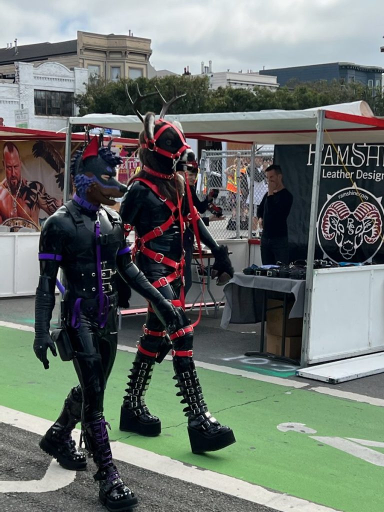 Two people in animal kink gear at Folsom 2022.