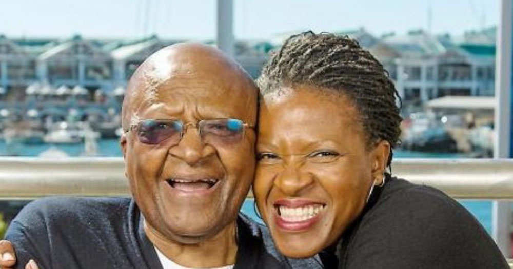 The photograph shows Mpho Tutu with her father Bishop Desmond Tutu. Mpho is hugging her father. both are grinning and looking directly at the camera.