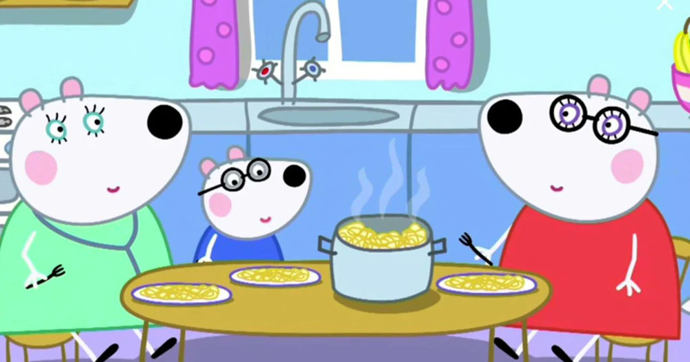 The image shows an animated still from the cartoon Peppa Pig. in the image Penny Polar bear is sitting with her two lesbian mummies eating spaghetti.