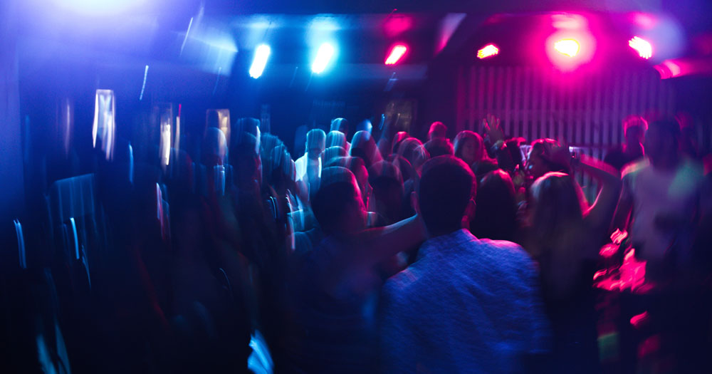 A new club night TENDER will launch in Dublin this Friday. The image shows a blurry photo of people dancing at a club with pink and blue light.