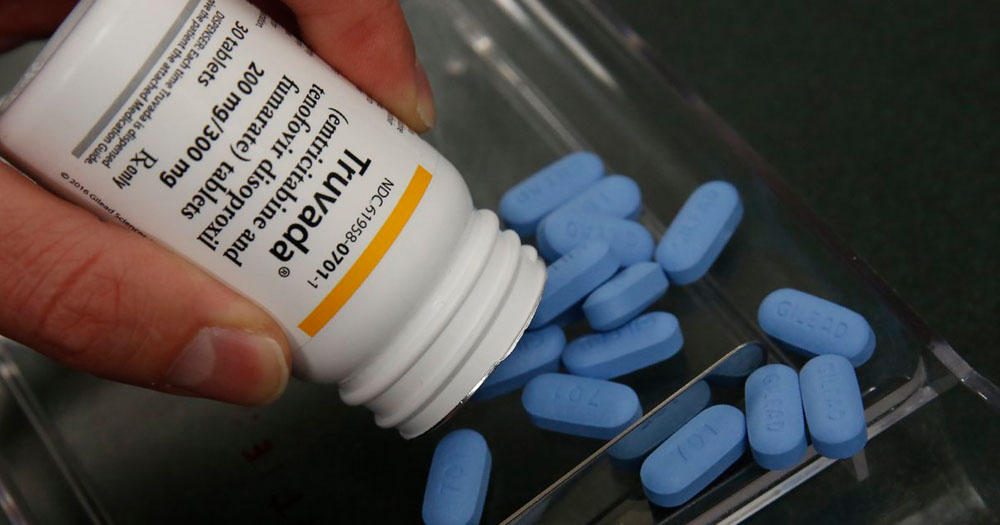 PrEP has been removed from the Affordable Care Act by a Judge in Texas. The image shows a PrEP drug called Truvada being emptied from a white container onto a glass plate. The pills are blue.