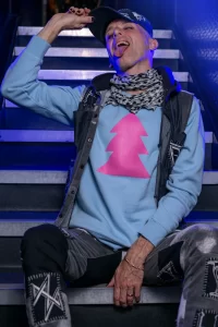A model wearing a 'Pink Triangles Tree' sweatshirt from the new GCN collection.