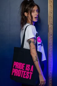 New GCN Collection A model wearing a 'Pride is a protest' tote bag from the new GCN collection.