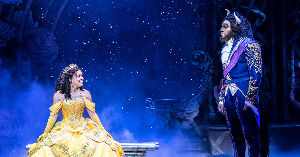 An image of Belle and Beast on stage.