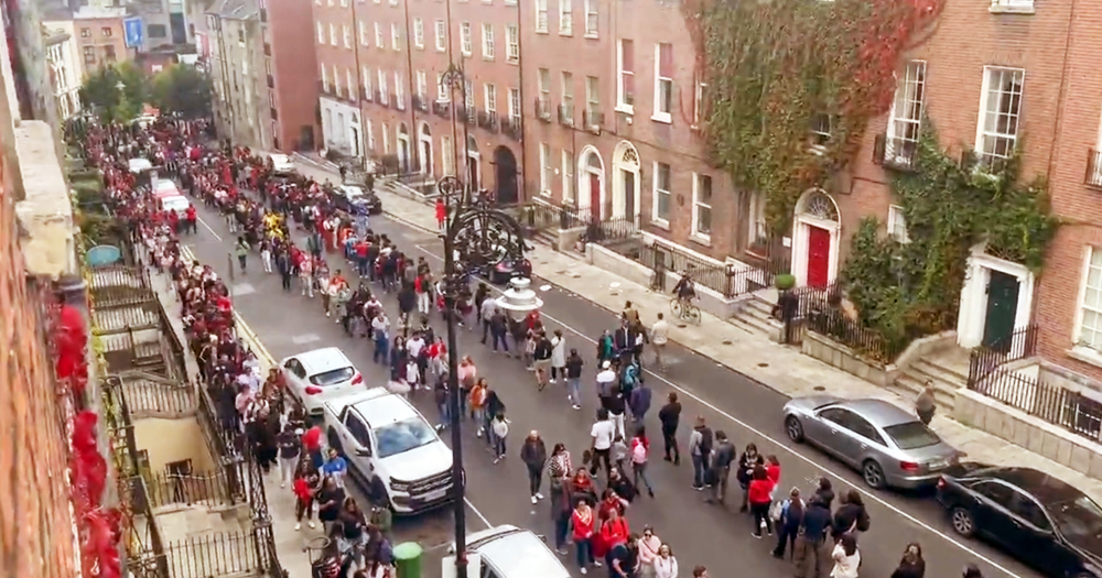 Thousands of people queue in several lines along the street to cast their votes in the Brazilian presidential election in Dublin.