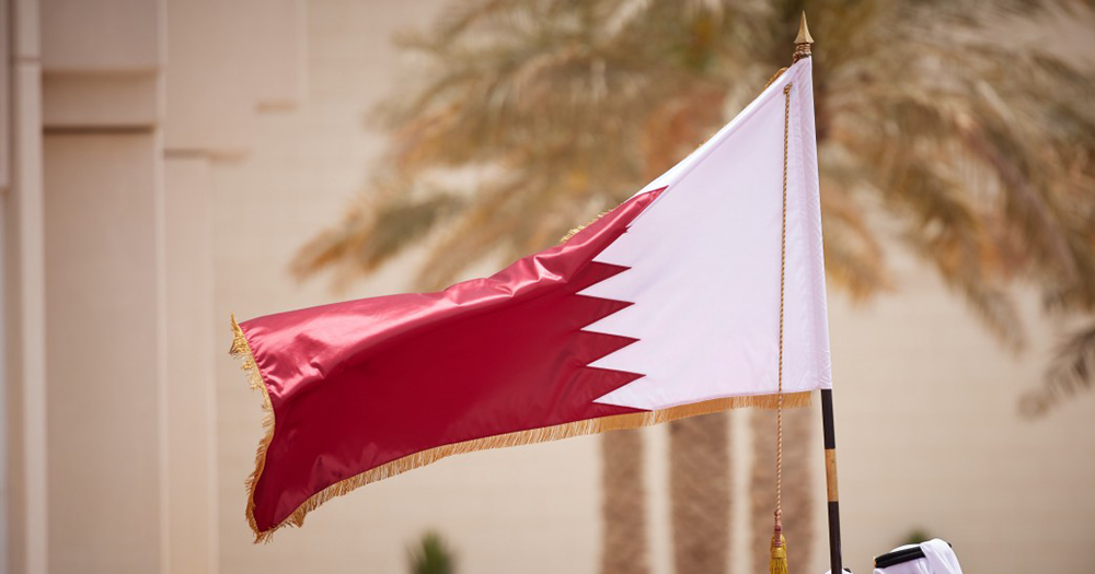 A Qatar flag blowing in the wind.