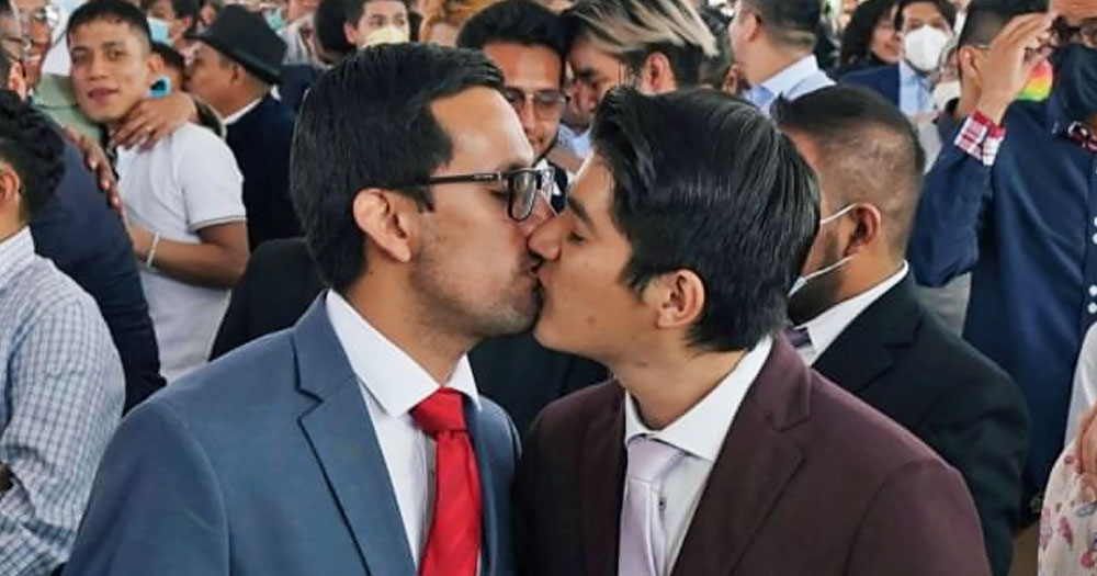 Marriage equality is now establish across Mexico. In the photo, two Mexican men kissing among a large group of people.