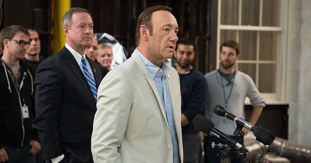 Kevin Spacey speaks at a microphone.