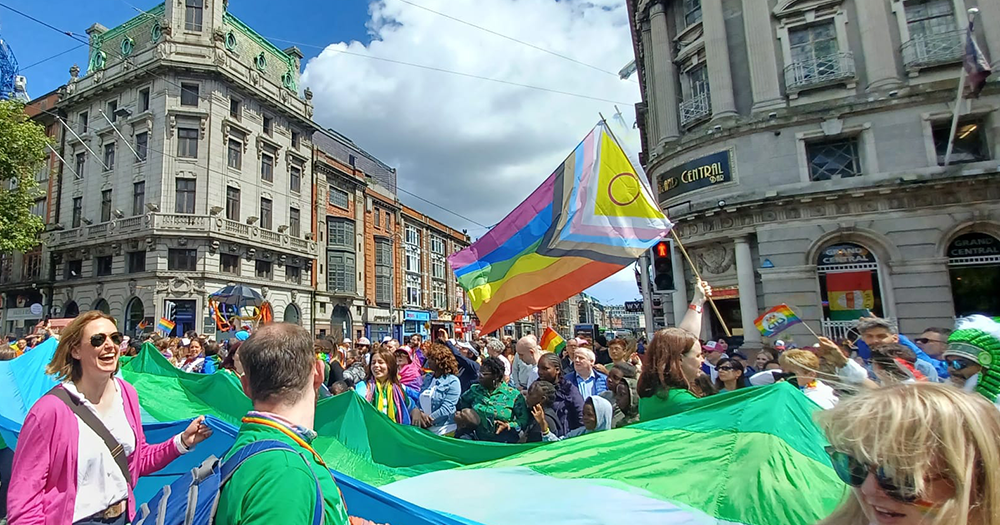 A LGBTQ+ Pride flag in a crowd at Dublin Pride.