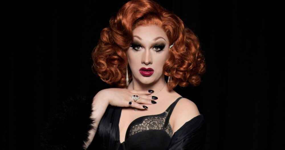 Famous drag queen, Jinkx Monsoon, poses in a moody and dark setting as she announces her role in legendary Broadway musical, Chicago.