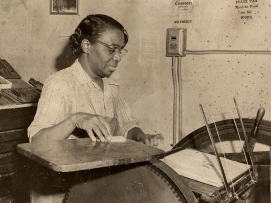 Ruth Ellis sits at her printing press that she owned with Ceceline Franklin.