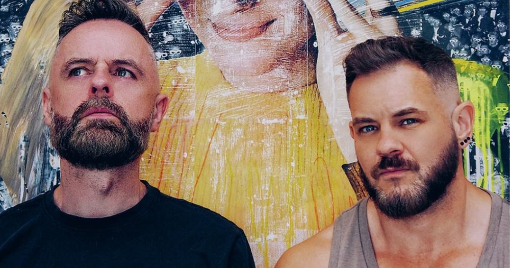 The art duo Adrian+Shane stand boldly against a brightly illustrated background as they talk to GCN about their experiences in the art world.