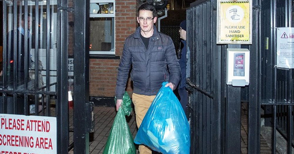 Enoch Burke being released from Mountjoy Prison, carrying his belongings in trash bags.